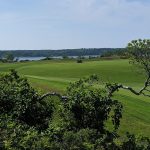 Panoramic view of a lush green golf course at Eastward Ho!. Smooth