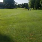 Panoramic view of a lush green golf course at Eberhart-Petro Municipal Golf Course. Smooth