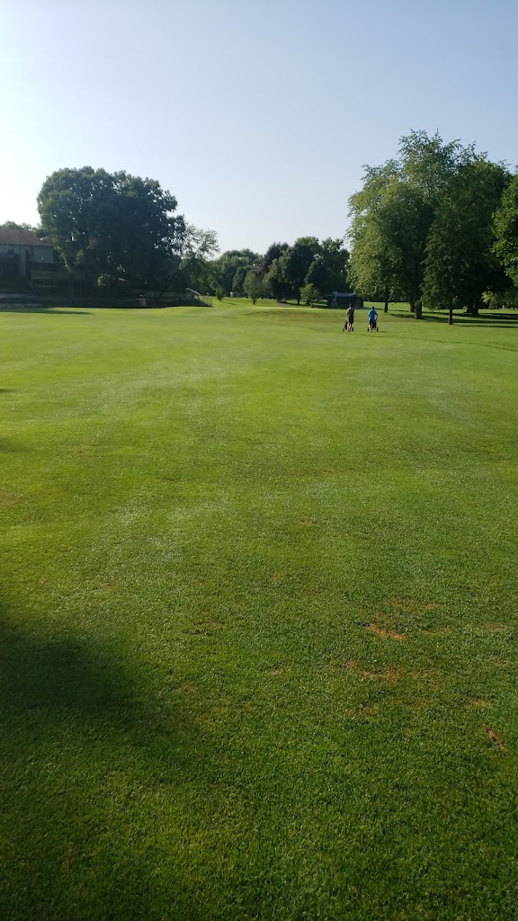 Panoramic view of a lush green golf course at Eberhart-Petro Municipal Golf Course. Smooth