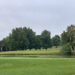 Panoramic view of a lush green golf course at Echo Hills Golf Club. Smooth