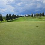 Panoramic view of a lush green golf course at Edgewater Country Club. Smooth