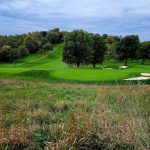 Panoramic view of a lush green golf course at Edgewood Country Club. Smooth