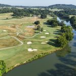 Panoramic view of a lush green golf course at Egwani Farms Golf Course. Smooth