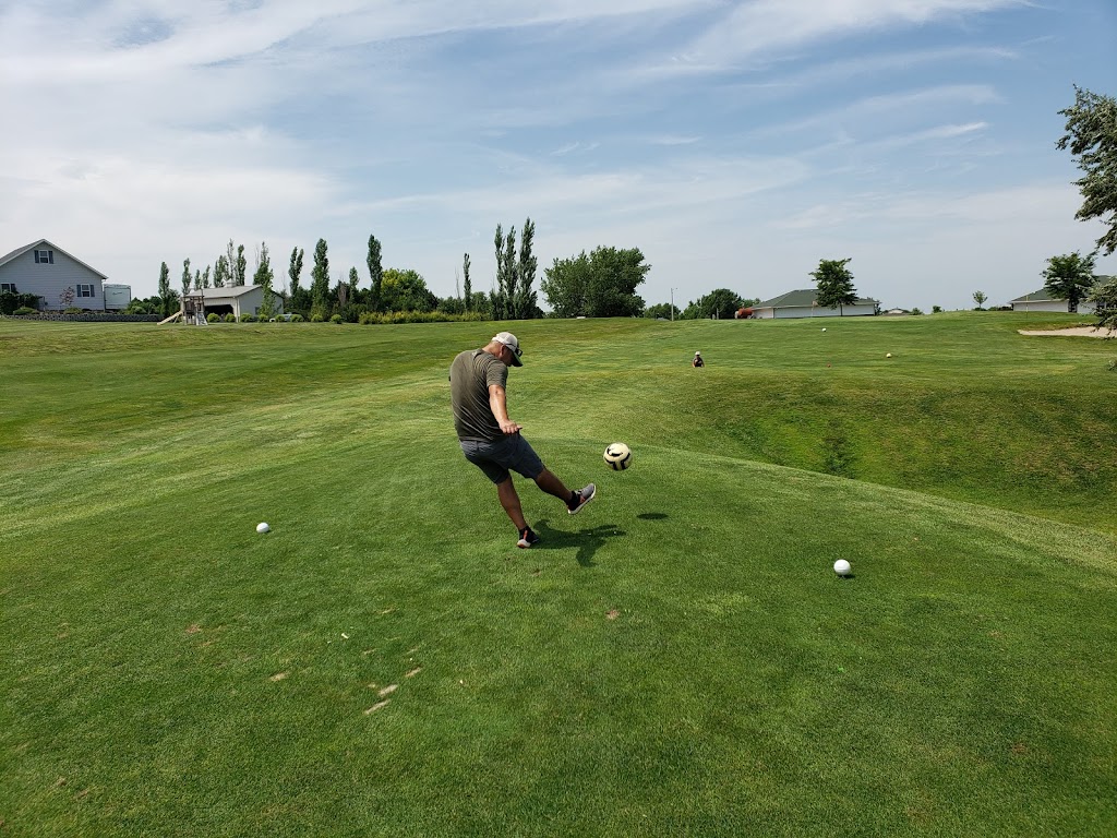 Panoramic view of a lush green golf course at Elks Country Golf. Smooth