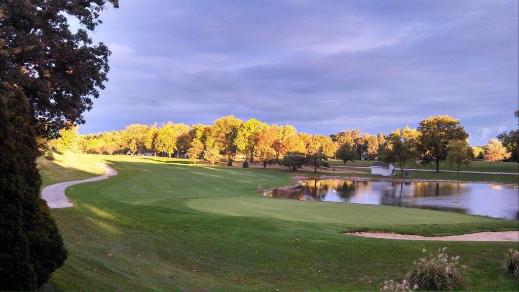Panoramic view of a lush green golf course at Ellis Golf Course. Smooth