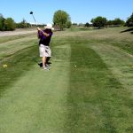 green grass with the flag in the hole.