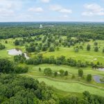 Panoramic view of a lush green golf course at Ellsworth Meadows Golf Club. Smooth