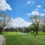 Panoramic view of a lush green golf course at Emeis Golf Course. Smooth