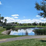 Panoramic view of a lush green golf course at Emerald Greens Golf Course. Smooth