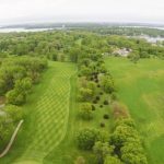 Panoramic view of a lush green golf course at Emerald Hills Golf Club. Smooth
