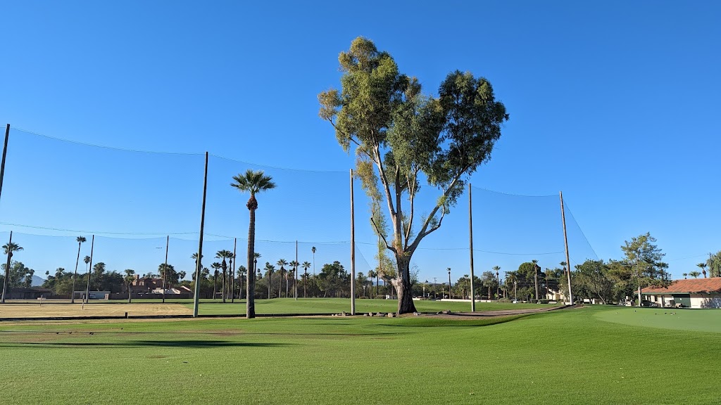 Panoramic view of a lush green golf course at Encanto 18. Smooth