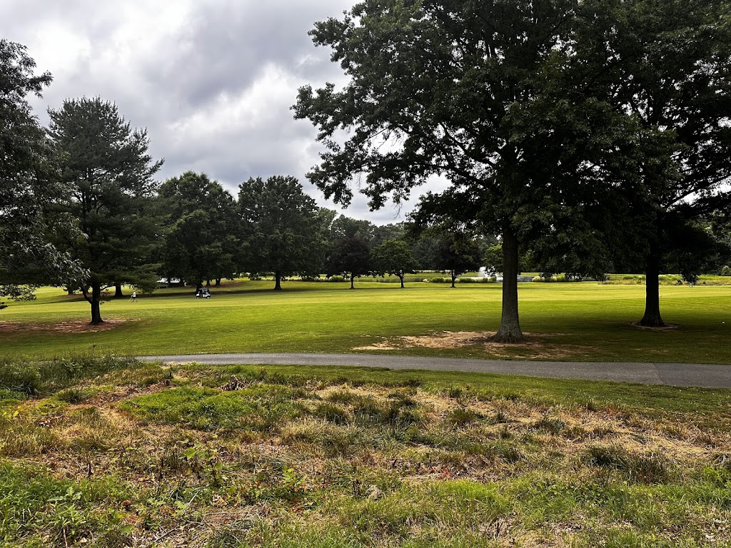Panoramic view of a lush green golf course at Enterprise Golf Course. Smooth