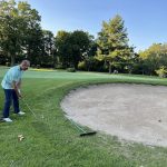 green grass with the flag in the hole.