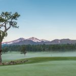 Panoramic view of a lush green golf course at Estes Park 18-Hole Golf Course. Smooth