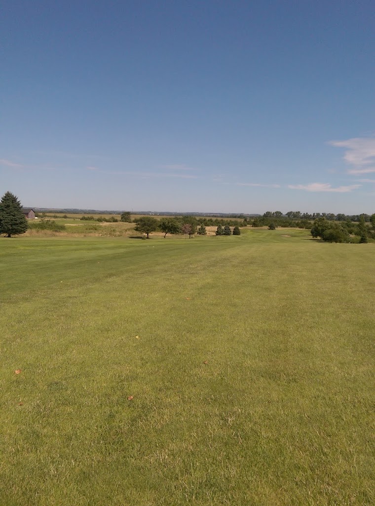 Panoramic view of a lush green golf course at Evergreen Hill Golf Course. Smooth