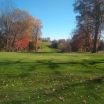 Panoramic view of a lush green golf course at Fairchild Wheeler Golf Course. Smooth