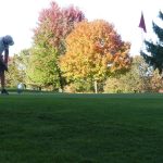 Panoramic view of a lush green golf course at Fairfield Hills Golf Course & Range. Smooth