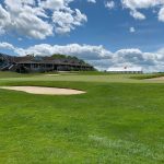 green grass with the flag in the hole.