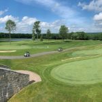 Panoramic view of a lush green golf course at Fairview Farm Golf Course. Smooth