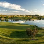 Panoramic view of a lush green golf course at Falcon Crest Golf Club. Smooth