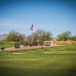 Panoramic view of a lush green golf course at Falcon Dunes Golf Course. Smooth