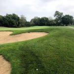 green grass with the flag in the hole.