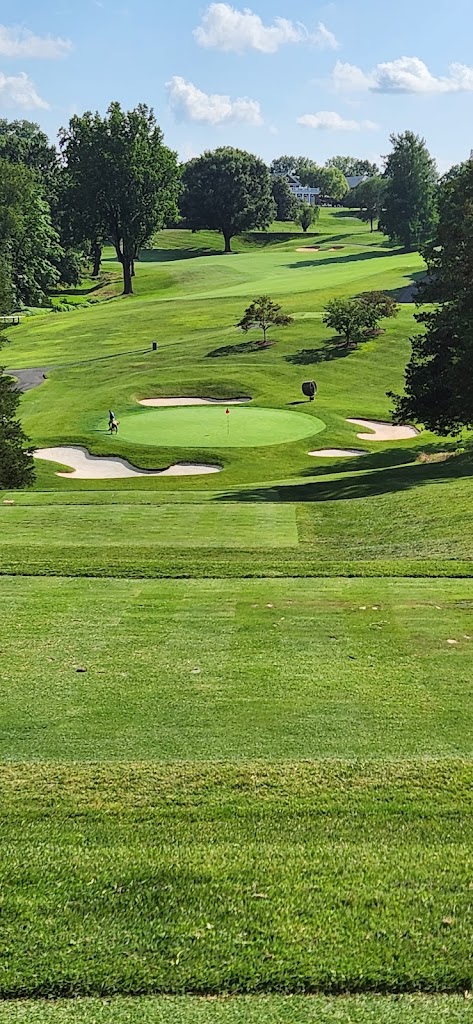Panoramic view of a lush green golf course at Farmington Country Club. Smooth
