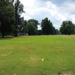 Panoramic view of a lush green golf course at Farnsley Golf Center. Smooth