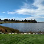 Panoramic view of a lush green golf course at Fenwick Golf Course. Smooth