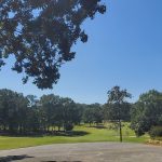 Panoramic view of a lush green golf course at Fields Ferry Golf Club. Smooth