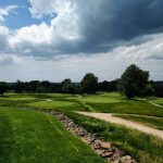Panoramic view of a lush green golf course at Fieldstone Golf Club. Smooth