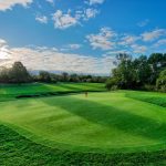 Panoramic view of a lush green golf course at Firekeeper Golf Course. Smooth