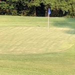 Panoramic view of a lush green golf course at First Tee - Central Arkansas. Smooth