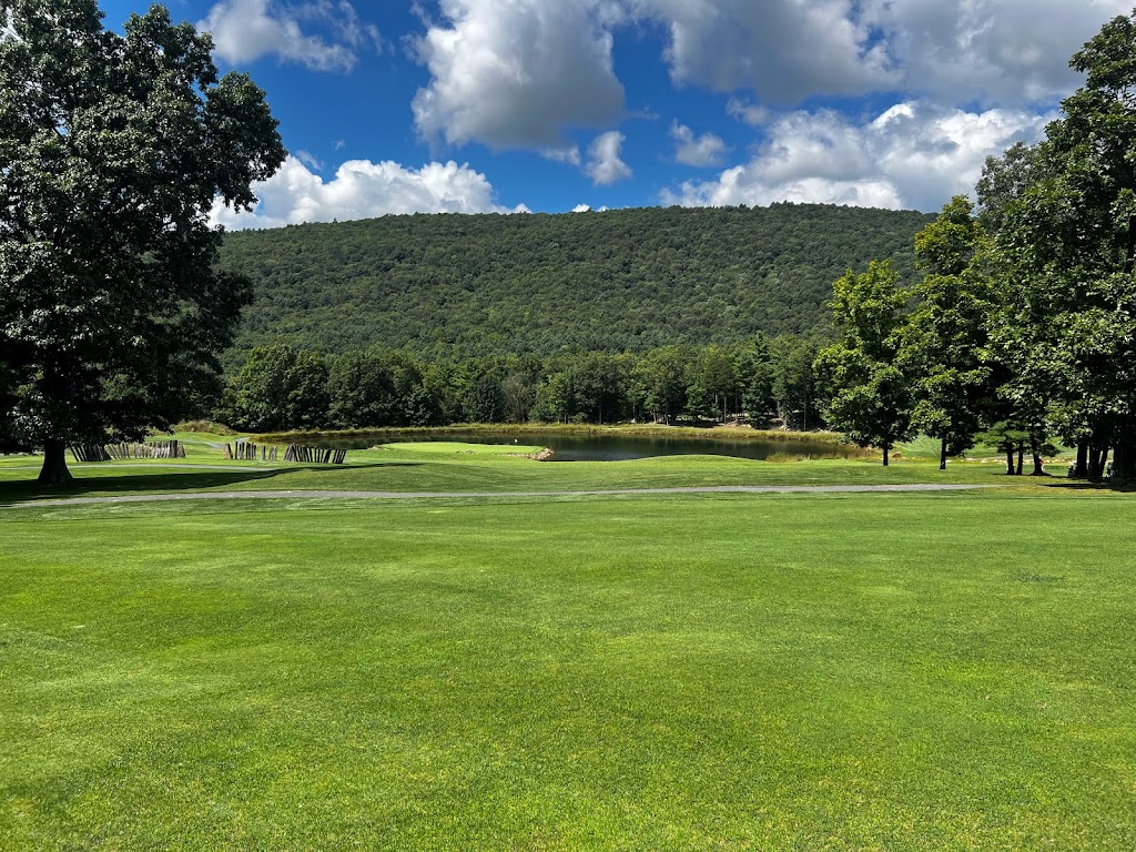 Panoramic view of a lush green golf course at Fisher Mountain Golf Club & Resort. Smooth