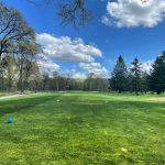 Panoramic view of a lush green golf course at Flanders Valley Golf Course. Smooth