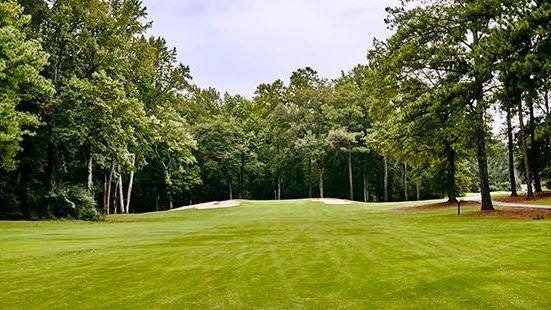 Panoramic view of a lush green golf course at Flat Creek Country Club. Smooth