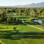 Panoramic view of a lush green golf course at Flatirons Golf Course. Smooth