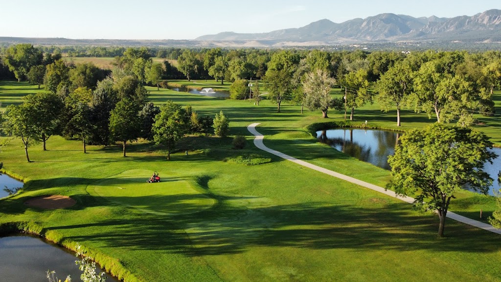 Panoramic view of a lush green golf course at Flatirons Golf Course. Smooth