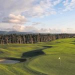 Panoramic view of a lush green golf course at Florence Golf Links. Smooth
