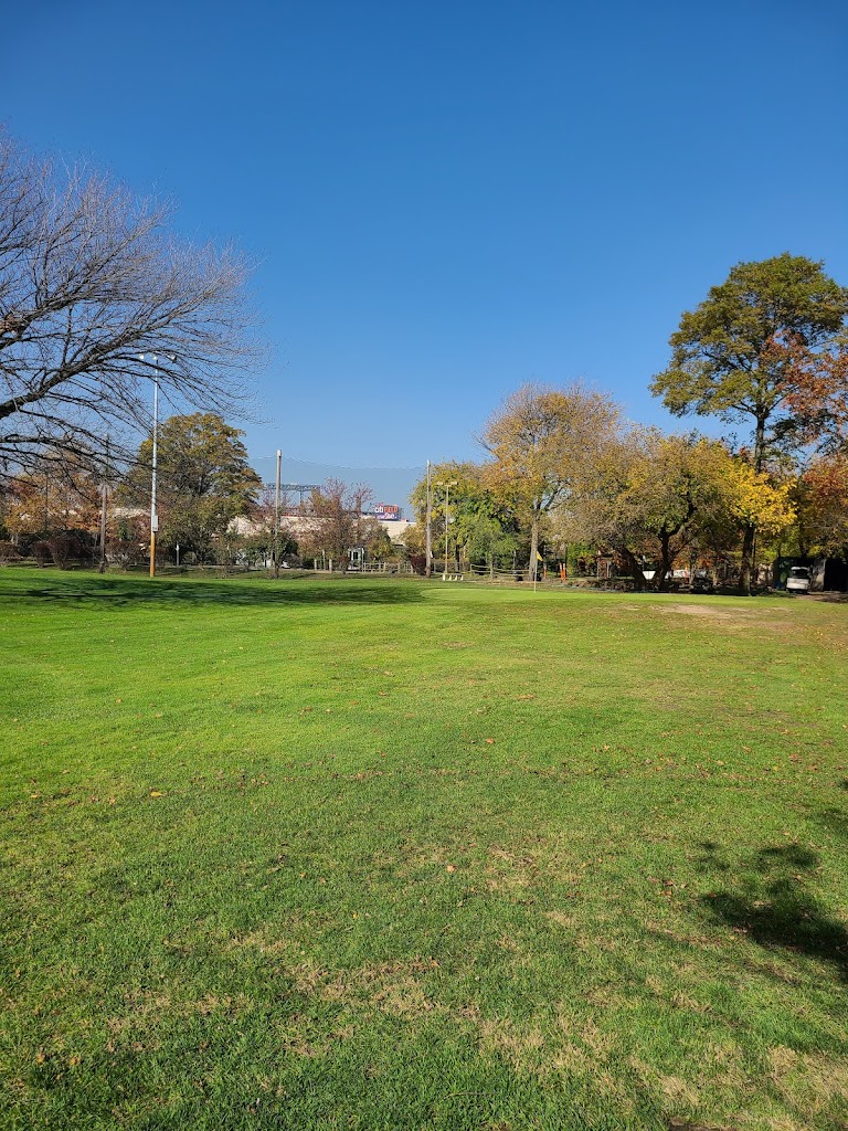 Panoramic view of a lush green golf course at Flushing Meadows Pitch & Putt. Smooth
