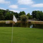 green grass with the flag in the hole.