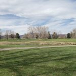 Panoramic view of a lush green golf course at Foothills Golf Course. Smooth