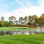 Panoramic view of a lush green golf course at Forest Creek Golf Club. Smooth