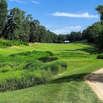 Panoramic view of a lush green golf course at Forest Greens Golf Club. Smooth