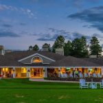 Panoramic view of a lush green golf course at Forest Highlands Golf Club. Smooth