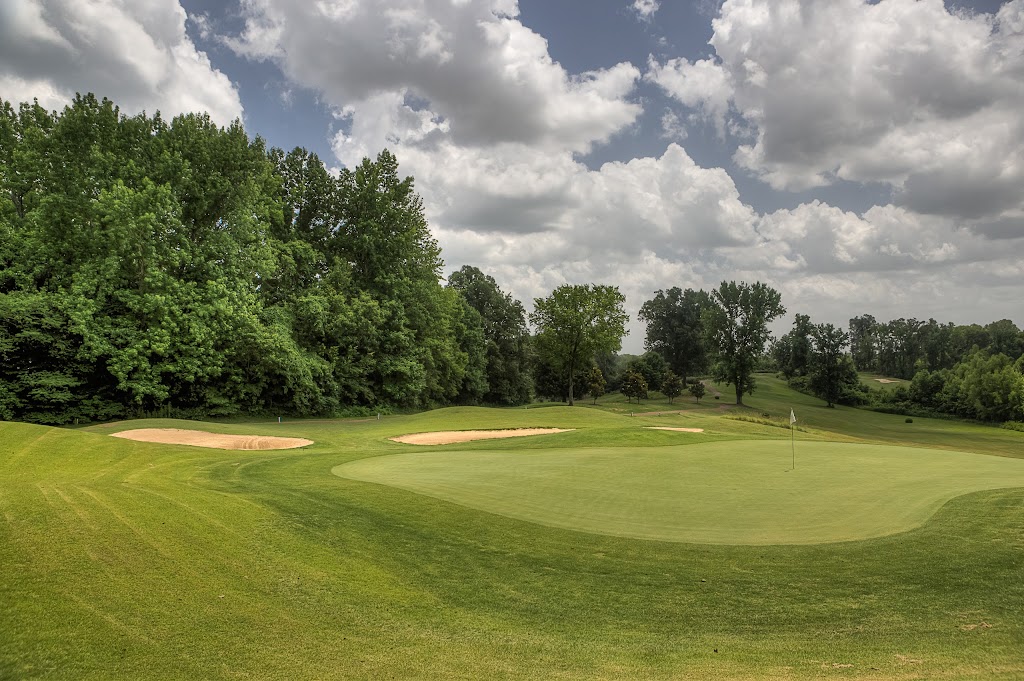 Panoramic view of a lush green golf course at Forest Hill Golf Course. Smooth