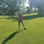 green grass with the flag in the hole.