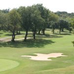 Panoramic view of a lush green golf course at Fort Sill Golf Course. Smooth