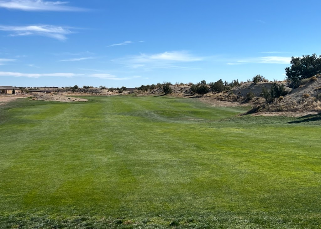 Panoramic view of a lush green golf course at Four Mile Ranch Golf Club. Smooth