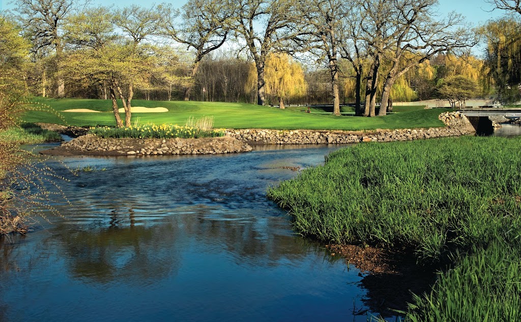 Panoramic view of a lush green golf course at Fox Bend Golf Course. Smooth